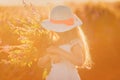 Portrait of cute young girl with long hair in a hat at sunset Royalty Free Stock Photo