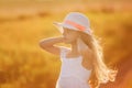 Portrait of cute young girl with long hair in a hat at sunset Royalty Free Stock Photo