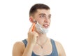 Portrait of a cute young guy with foam on his face who shaves his beard Royalty Free Stock Photo