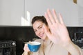 Portrait of cute young woman, covers herself from camera, laughing and flirting, drinking coffee in the morning Royalty Free Stock Photo