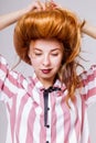 Portrait of cute young woman playing with her golden hair Royalty Free Stock Photo