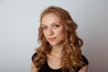 Portrait of cute young woman posing in the white studio.