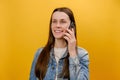 Portrait of cute young woman talking with friend on cell phone, looking away and smiling joyfully, having pleasant conversation, Royalty Free Stock Photo