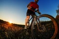 Portrait of cyclist standing with mountain bike on trail at sunset Royalty Free Stock Photo