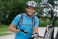 Portrait cyclist working with pump