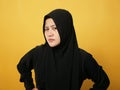 Portrait of cynical Asian muslim woman with suspicious expression looking and starring, mistrust misdoubt Royalty Free Stock Photo