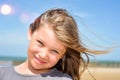 portrait of a pretty little girl with windy hair on the beach in summer Royalty Free Stock Photo