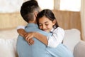 Portrait of daddy and daughter at home, girl hugging dad Royalty Free Stock Photo