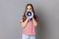 Little girl screaming in megaphone, speaking, announcing important information.