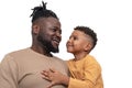 Portrait of dark skinned African male and his little son spending time together, isolated