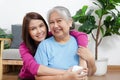 Portrait of a daughter with an elderly Asian mother smiling happily. Royalty Free Stock Photo