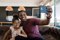 Daughter and father taking a selfie with phone. Royalty Free Stock Photo