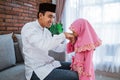 Daughter kissing hands to his father apologize on eid mubarak