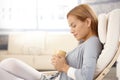 Portrait of daydreaming woman with tea cup