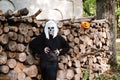 Portrait of dead bride, who is standing near the sawn logs. Next to the carved pumpkin for Halloween Royalty Free Stock Photo