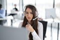 Portrait of dedicated female operator agent working at IT support sector.