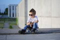 A portrait of defiant boy with skateboard outdoors.