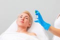 Portrait of defocused caucasian woman lying on a couch and looking at test tube in doctor& x27;s hand. Copy space. The