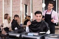 Delighted male client after haircut in salon