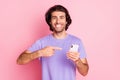 Portrait of delighted person toothy smile finger indicate phone purple clothing isolated on pink color background