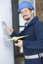 portrait delighted plasterer with plastering tools at indoors site