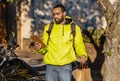 Portrait of delivery man in front of the delivery place checking delivery spreadsheet