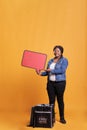 Portrait of deliverywoman holding red speech bubble advertisting takeaway food service Royalty Free Stock Photo