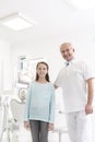 Portrait of dentist and girl patient at dental clinic