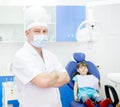 Portrait dentist with patient in the background.