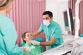 Portrait of dentist and patient at dental clinic