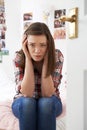 Portrait Of Depressed Teenage Girl In Bedroom Royalty Free Stock Photo