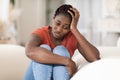 Portrait Of Depressed Young Black Woman Sitting On Couch At Home Royalty Free Stock Photo