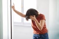 Portrait Of Depressed Young Woman Crying Near Window At Home Royalty Free Stock Photo