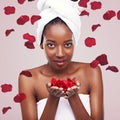 Portrait, dermatology and black woman with red petals, beauty and treatment on a white studio background. Face, African Royalty Free Stock Photo