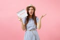 Portrait desperate woman in blue dress, hat holding periods calendar for checking menstruation days isolated on bright