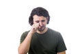 Portrait of desperate young man crying and wiping the tears with his hand isolated on white background. Dissatisfied and Royalty Free Stock Photo