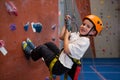 Portrait of determined boy practicing rock climbing Royalty Free Stock Photo