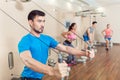 Determined young man exercising with resistance bands