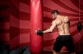 Portrait of determined male professional boxer, getting ready for fight, training and practicing