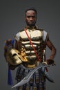 African warrior from ancient greece against grey background