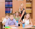 Portrait of diligent schoolgirl at lesson surrounded by her classroom