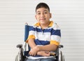 Portrait of disable kid boy on wheelchair with happy smile face