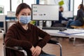 Portrait of disabled businesswoman with medical face mask Royalty Free Stock Photo