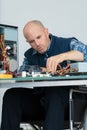 portrait disabled man repairing computer