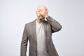 Portrait a disappointed mature man covering his face with his hand. Royalty Free Stock Photo