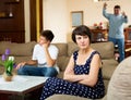 Disappointed woman with husband scolding teen son