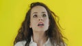 Portrait of discontent woman expressing aversion and demonstrating her disgust in Studio with yellow Background.
