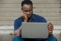 Portrait of a discontented young man with laptop Royalty Free Stock Photo
