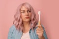 Portrait of young woman with aching teeth, pain in sensitive bleeding gums, brushing teeth. Dental care Royalty Free Stock Photo