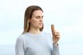 Disgusted woman looking to a snack bar on the beach